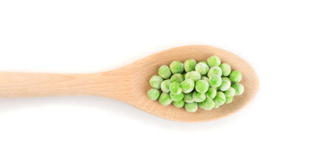 Heap of Frozen Sweet Green Peas in Wooden Spoon Isolated on White Background Top Viewの写真素材