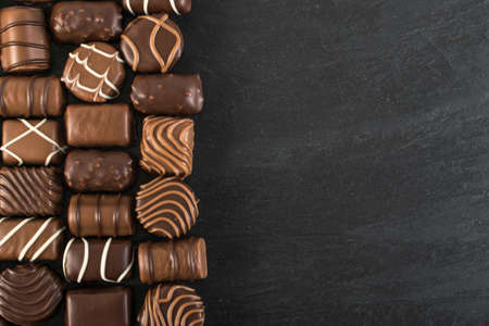 Beautiful Creative Chocolates Candies Background. Chocolate Wallpaper Top View and Flat Layの写真素材