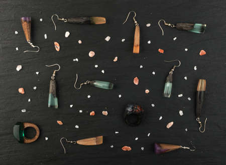 Different Pendants and Rings Jewelry Pattern Top View. Bijouterie Made of Epoxy Resin and Woodの写真素材