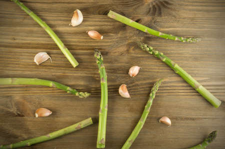 Raw Garden Asparagus Pattern Top View. Fresh Green Spring Vegetables on Wooden Background. Edible Sprouts of Asparagus Officinalis Flat Layの写真素材