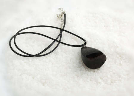 Hand Made Pendant of Dark Color on White Crystal Background. Bijouterie Made of Epoxy Resin and Woodの写真素材