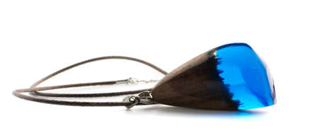 Pendant of Blue Color Isolated on White Background. Bijouterie Made of Epoxy Resin and Woodの写真素材