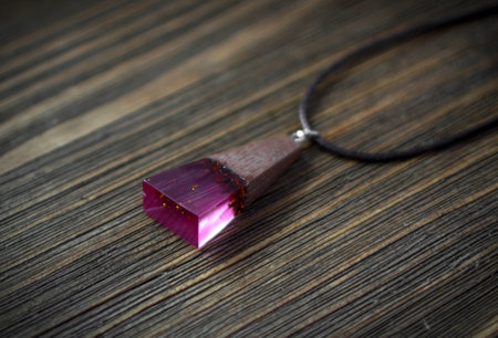 Pendant of Pink Color on Wooden Background. Bijouterie Made of Epoxy Resin