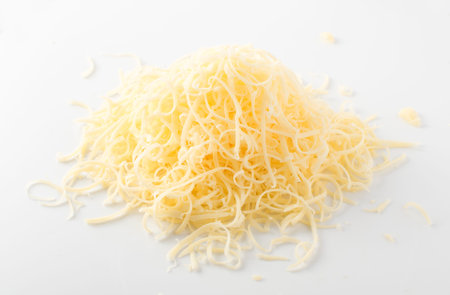Pile of grated cheese on white background. The photo from aboveの写真素材
