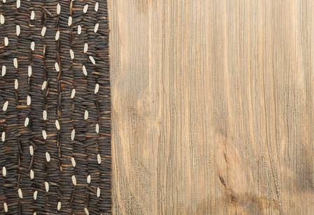 Smooth Tidy Ranges of Raw Black Wild Rice on Wood Background Top View. Healthy Dietetic Canada Rice Cereal Texture with Place for Textの写真素材