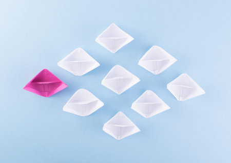 One Unique Pink Paper Boat among Many Ones. Different Paper Ships as Individuality and Leadership...