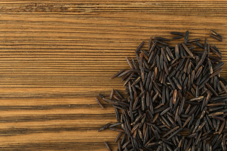 Raw Black Wild Rice Background Top View. Healthy Dietetic Canada Rice Cereal Texture with Place for Textの写真素材