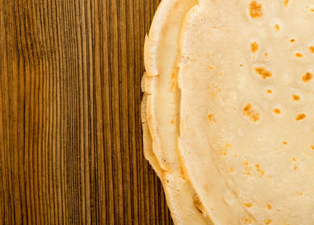 Thin Pancakes or Tortilla on Wooden Table Background Top View. Fresh Homemade Crepes or Flatbread Flat Lay with Space for Textの写真素材