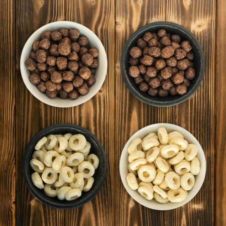 Bowl with Corn Rings and Balls for Breakfast on Wooden Background. Healthy Cereal Vegetarian Food...