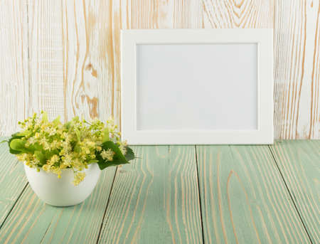 Linden Flowers on Wooden Background. Beautiful Summer Bouquet over Wood Table Texture. Tilia Blossom with Place for Textの写真素材