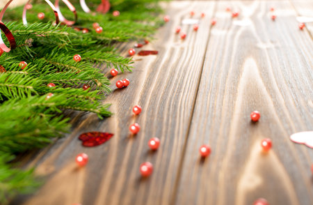 Christmas background with fir branches on wooden backdrop flat lay and top view. Yuletide floral...