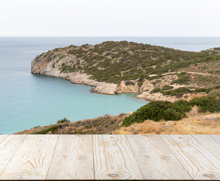Wood table outside with seaview in beautiful summer day. Rustic wooden desk outdoor on sea view background. Template mock up with countertop for product advertisingの写真素材