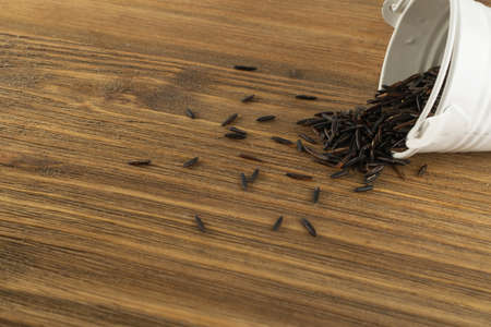 Raw Black Wild Rice Background Top View. Healthy Dietetic Canada Bio Rice Cereal Texture with Place for Textの写真素材