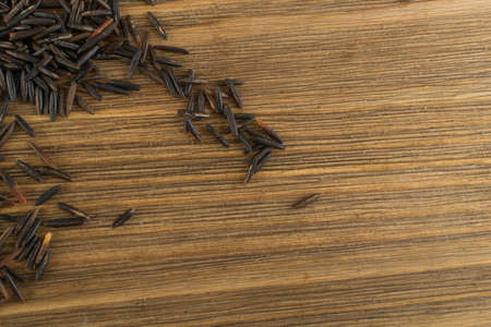 Raw Black Wild Rice Background Top View. Healthy Dietetic Canada Bio Rice Cereal Texture with Place for Textの写真素材
