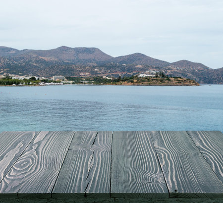 Wood table outside with seaview in beautiful summer day. Rustic wooden desk outdoor on sea view...
