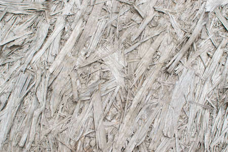Old grey chipboard background top view. Aged osb panel texture or pressed and glued wood chips backdropの写真素材