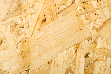 Chipboard background top view. Light brown osb panel texture or pressed and glued wood chips backdropの写真素材