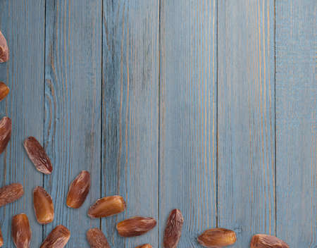 Dried Dates on Wooden Background Top View Flat Lay. Fruits of Date Palm or Phoenix Dactylifera with Place for Textの写真素材