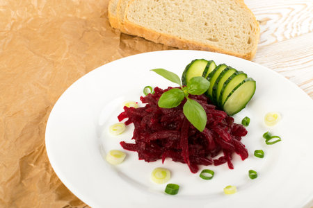 Exquisite Serving Restaurant Plate of Grated Pickled Beet Root Salad on Rustic Background. Macro...
