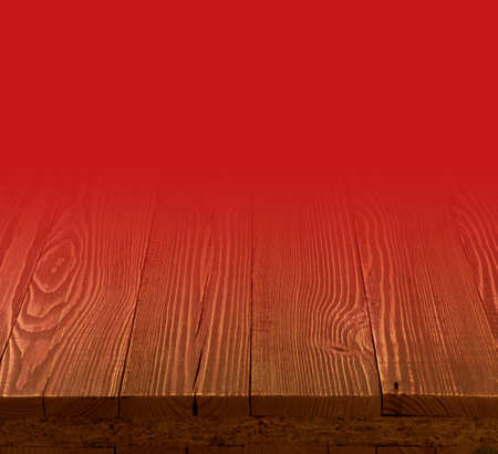Red gradient background with wood floor perspective and place for text. Rustic wooden desk template mock up with countertop for product advertisingの写真素材
