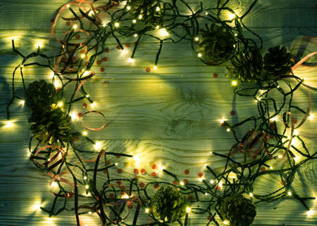 Christmas Light on Wooden Background Top View with Copyspace. Garland Lights on Vintage Wood Texture for New Year Frame or Xmas Mockupの写真素材