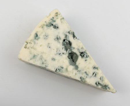 Wedge of gorgonzola, neufchatel or danablue close up. Macro photo of blue cheese piece with mold