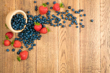Fresh Beautiful Strawberries and Blueberries on Old Vintage Wooden Backgroundの写真素材