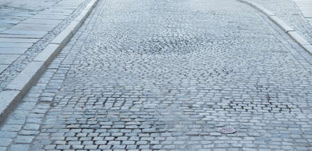 Grey Old Pavement Top View or Granite Cobblestone Road. Ancient Brick Cobblestoned Floor or Granite Tiles Street with Big Stonesの写真素材
