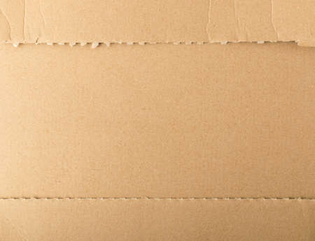 Brown cardboard paper background. Recycled paperboard texture or pattern top viewの写真素材