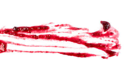 Dark red berry jam blot or spot isolated on white background. Sweet confiture drops or marmalade splash top viewの写真素材