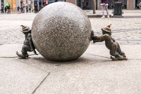 BRZEG, POLAND - March 07, 2019: Wroclaw Sisyphean Task Gnome Sculpture in Historical City Center Near the Market Square. Editorial Image of Dwarf in Silesia Voivodeship Townのeditorial素材