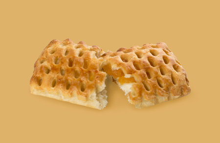 Sweet braided puff pastry or pate feuilletee on beige backgroun. Fresh phyllo pastry or square patty...