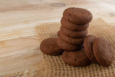 Heap of soft homemade chocolate butter cookie with chocolate filling on rustic table background....