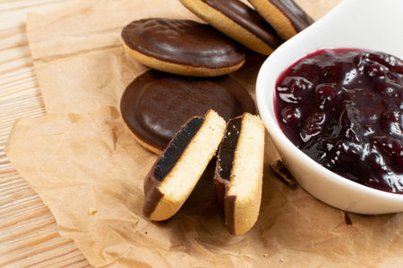 Jaffa cake or biscuit cookie filled with natural jam. Round chocolate covered cookies with fruit...