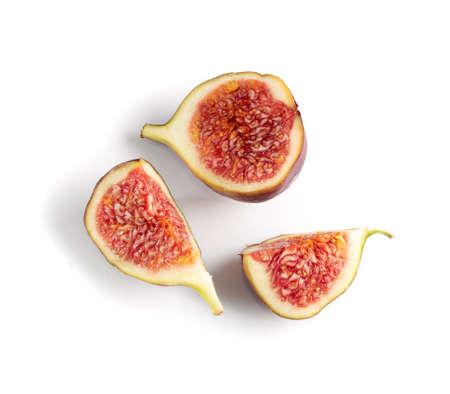 Fresh cut fig fruit isolated on white background closeup. Macro shot ficus carica or common fig fruits top viewの写真素材