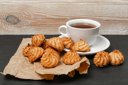 Natural baked coconut cookies or cocoanut macaroons with tea or coffee. Homemade diet biscuits with coco chipsの写真素材