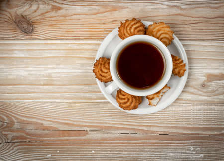 Natural baked coconut cookies or cocoanut macaroons with tea or coffee. Homemade diet biscuits with coco chips top view, copy spaceの写真素材