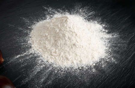 Chestnut flour with edible sweet whole chestnuts close up. Raw healthy delicious chestnut powder, autumn and christmas veggie foodの写真素材