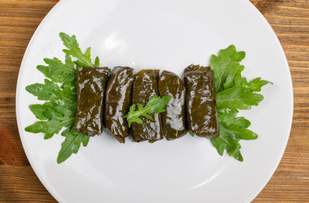 Macro Photo of Traditional Turkish Dolma, Sarma or Dolmades on White Restaurant Plate. Mediterranean...