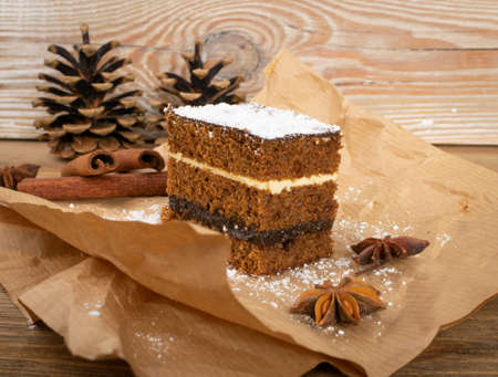 Traditional polish Christmas desert piernik, pryanik or sponge cake with spices. Rectangular piece of brown cocoa tart, gingerbread or layer biscuitの写真素材