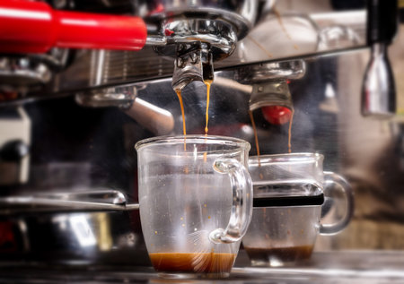 Macro shot of preparing espresso on professional coffee machine in coffeeshop or cafe closeup....