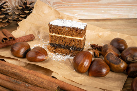 Homemade chestnut cake desert or sponge cake with spices on kraft paper. Rectangular piece of brown...