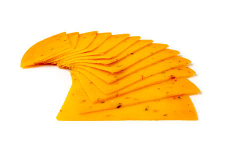 Orange hot cheese with chili pepper and paprika. Sliced cheese with herbs and spices isolatedの写真素材