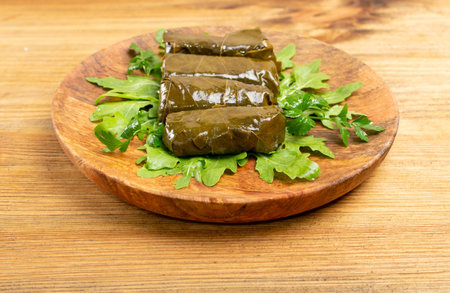 Macro Photo of Traditional Turkish Dolma, Sarma or Dolmades on Wooden Plate. Mediterranean Dish...
