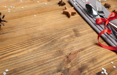 Christmas Dinner Table Setting with Cutlery, Grey Napkin and Winter Spices Top View. Festive...