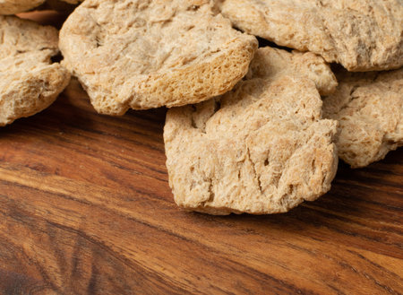 Raw dehydrated soy meat or soya chunks on wood background top view. Texturized vegetable protein,...