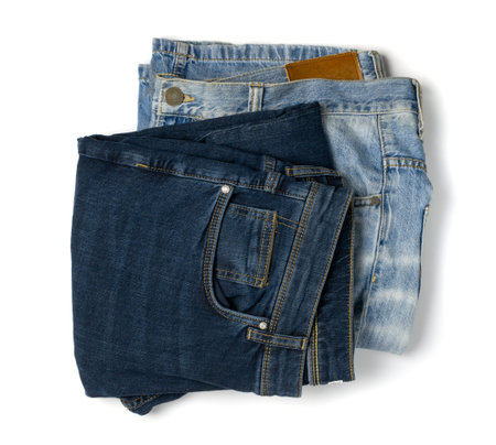 New dark blue jeans and light blue old jean top view. Indigo denim pants isolated on white...