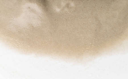 Light beige wet sand texture pattern, damp sandy beach textured background top view with copy spaceの写真素材