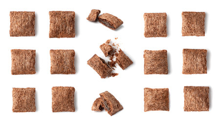 Set of chocolate pillows for breakfast isolated on white background. Brown choco cereal pads with cream, crispy corn flakes collection, healthy sweet snackの写真素材