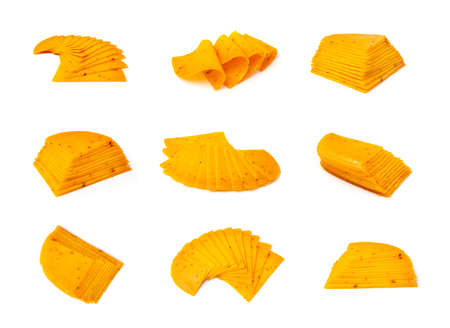 Orange hot cheese with chili pepper and paprika. Sliced cheese with herbs and spices isolatedの写真素材